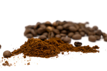 Ground coffee and coffee beans isolated on white background