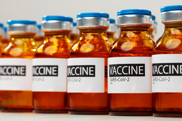 Sars-cov-2 vaccine vial bottles on white table
