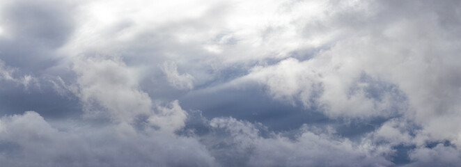 Naklejka na ściany i meble Cloudy sky with dramatic rain clouds, panorama