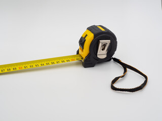 Construction roulette.Black and yellow measuring device on a white background.