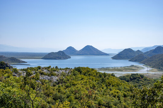 Beautiful view Skadar (Skoder) lake among the mountains. This section of the lake overgrown with tall grass. Montenegro.