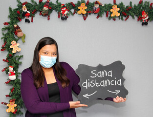 Latin woman with protection mask and blackboard with 