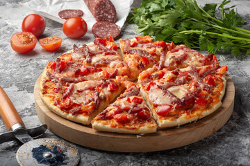 Pizza with sausage, sweet pepper and tomatoes. Assorted pizza. Pizza with sausage.