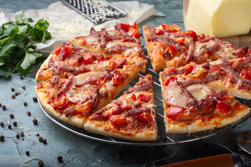 Pizza with sausage, sweet pepper and tomatoes. Assorted pizza. Pizza with sausage.