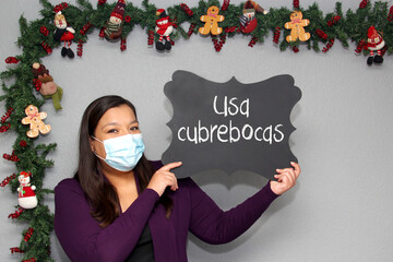 
Latin woman with protection mask and blackboard with message 