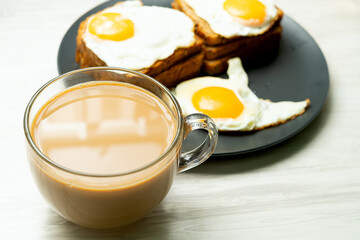 Fried Egg on Wholegrain Toast and cup of Coffee for Breakfast.