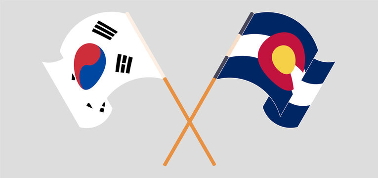 Crossed and waving flags of South Korea and The State of Colorado