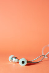 Naklejka premium headphones on a orange background 
