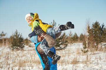 playing father and son in the winter outdoors - 394774522