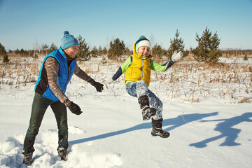 playing father and son in the winter outdoors - 394774587