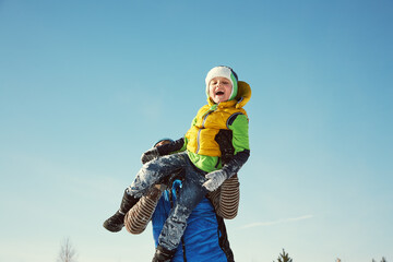 playing father and son in the winter outdoors - 394774723