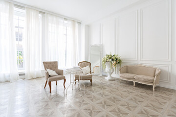 Naklejka na ściany i meble Luxury white interior of living spacious room with elegant chic furniture and high windows.