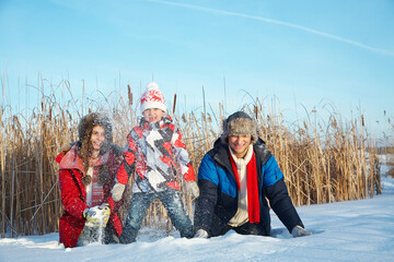 happy playing family in the winter. people outdoors - 394775393