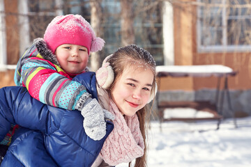 Fototapeta premium children playing in the yard of his house in the winter outdoors