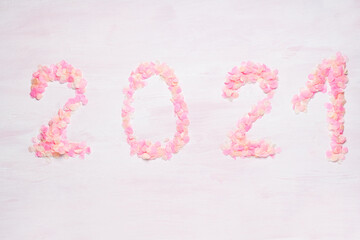 Happy New year 2021 celebration. Bright pink confetti on pink background. Christmas and new year celebration