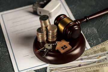 Real Estate Law concept. Wooden model of house, coins and judge gavel.