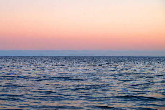 pink sunset sky, blue skyline and sea, natural background