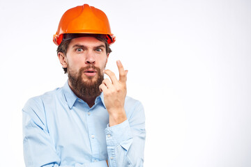 Man in an orange helmet shirt Engineering work construction cropped view