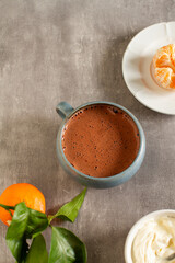 
Cup of hot chocolate on a table with winter decorations