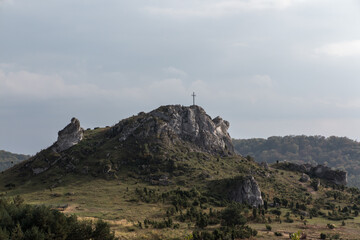 Fototapeta na wymiar The cross on the background of clear sky at the top Biaklo (or Maly Giewont) near Olsztyn near Czestochowa