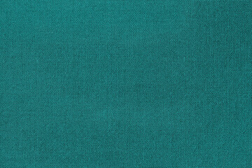 Texture of colorful canvas or burlap closeup, dark turquoise color, bright background