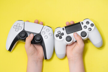 Next Gen and old gen controllers on Kids hand. © miglagoa