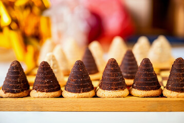Sweet beehive on chessboard, blurred gift on background.