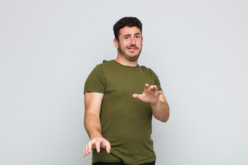 young man feeling disgusted and nauseous, backing away from something nasty, smelly or stinky,...