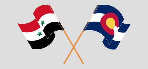 Crossed and waving flags of Syria and The State of Colorado
