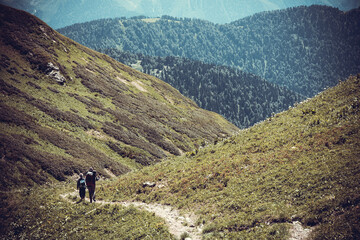 Fototapeta na wymiar Beautiful mountain landscape with tourists hiking at Caucasus mountains.