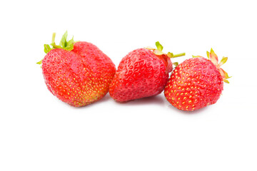 Three strawberries with strawberry leaf on white background.