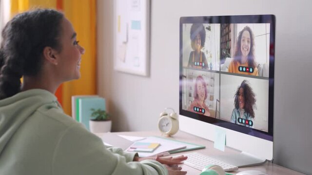 African american teenage girl chatting with happy multiethnic diverse teen friends during online virtual chat video call in group conference distance chat virtual meeting using computer at home.