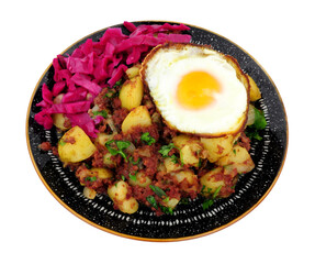 Corned beef hash meal with a crispy fried egg and pickled red cabbage isolated on a white background