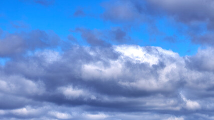 Dark clouds against a blue sky