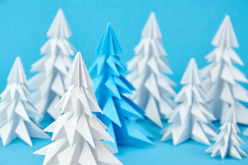 White and blue paper origami christmas trees composition