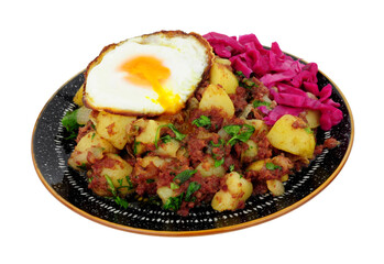 Corned beef hash meal with a crispy fried egg and pickled red cabbage isolated on a white background