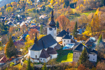 The Spania Dolina village with church and historic buildings in valley of autumn  landscape, Slovakia, Europe. - obrazy, fototapety, plakaty