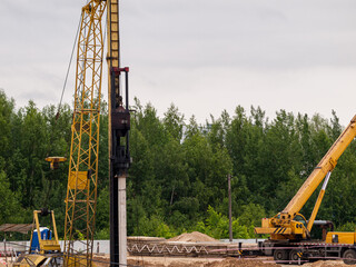 Drop hammer while working on driving piles, diesel hammer strikes a series of blows on a concrete...