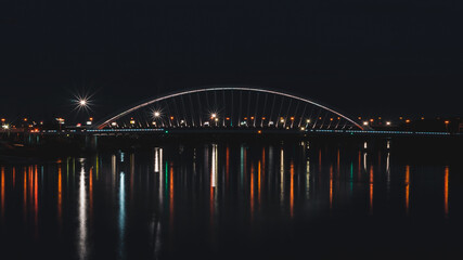 Fototapeta na wymiar Bratislava, Slovakia, November 20, 2020, Apolo bridge over the river Danube in Bratislava during the night.