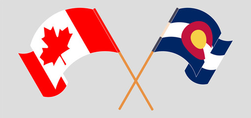 Crossed and waving flags of Canada and The State of Colorado