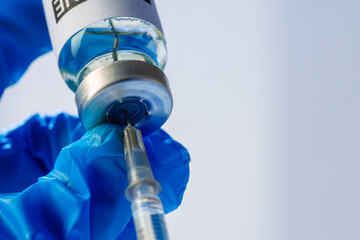 Doctor hands holding glass vial with medication