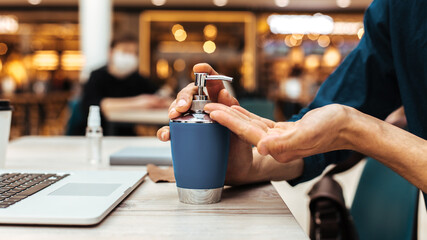 close up. man applying a decontaminating gel to his hands.