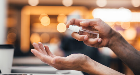 close up. man spraying antiseptic hand spray.