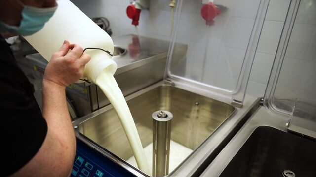 pour the milk into the pasteurizer for the preparation of ice cream. slowmotion