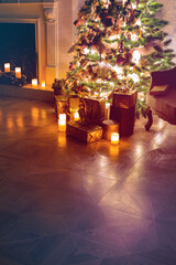 Luxury interior of living room with decorated Christmas tree and gifts on the wooden floor