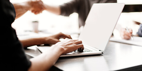 close up. image of a man working on an office laptop .