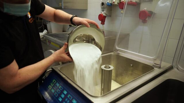 pour the sugar into the pasteurizer for the preparation artisanal ice cream