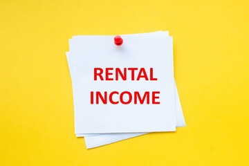 Word rental income on white sticker with yellow background