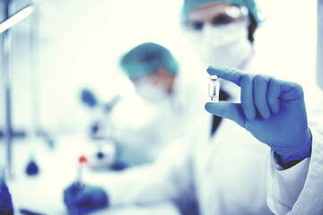 background image of a scientist recording test results in a lab log.