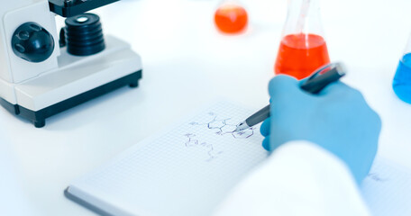 close up. scientist looking at a drop of blood through a microscope.